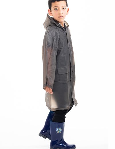 Kid wearing a transparent black waterproof coat and blue boots