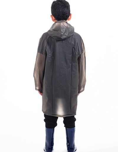 Kid from behind wearing a transparent black waterproof coat and blue boots