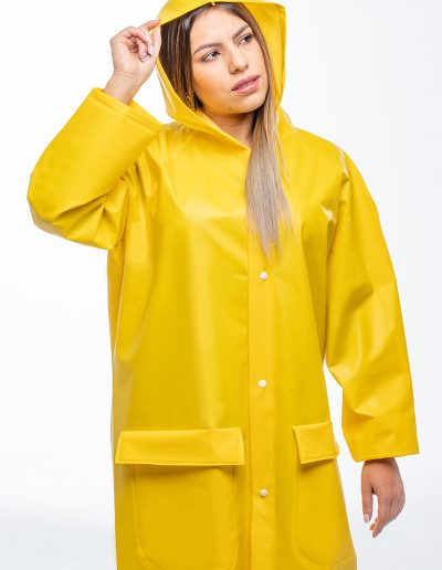 Woman wearing a waterproof coat with hood and indirect ventilation