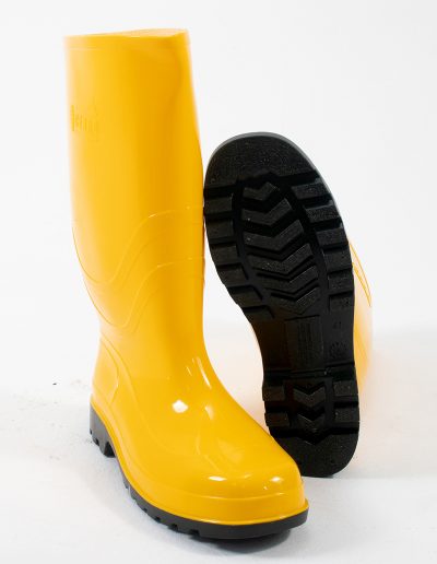 Detail of a yellow rubber safety swamp boot and a sole
