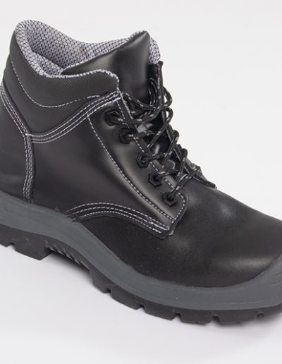 Detail of the sole of a black leather safety boot