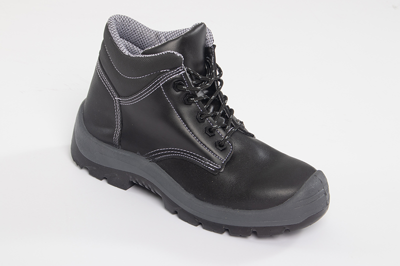 Detail of the sole of a black leather safety boot