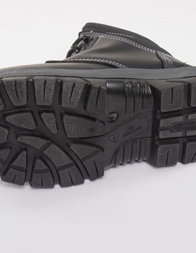 Detail of the sole of a black leather safety boot