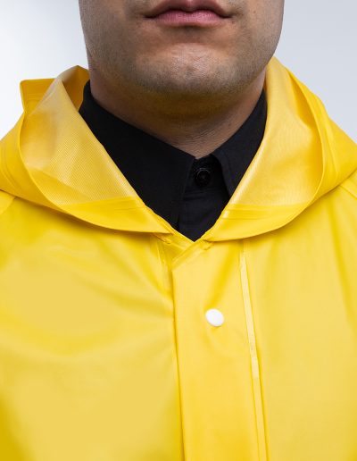 Man wearing a two-piece waterproof suit with snap fasteners