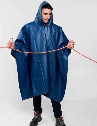 Man wearing a blue waterproof poncho and holding a red rope