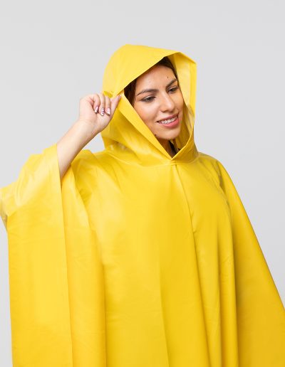 Woman wearing a yellow waterproof plains poncho