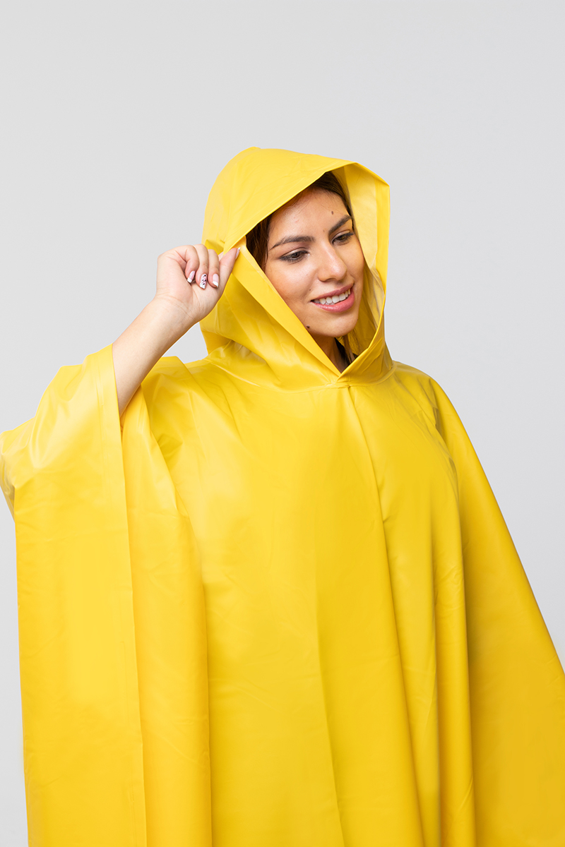 Woman wearing a yellow waterproof plains poncho